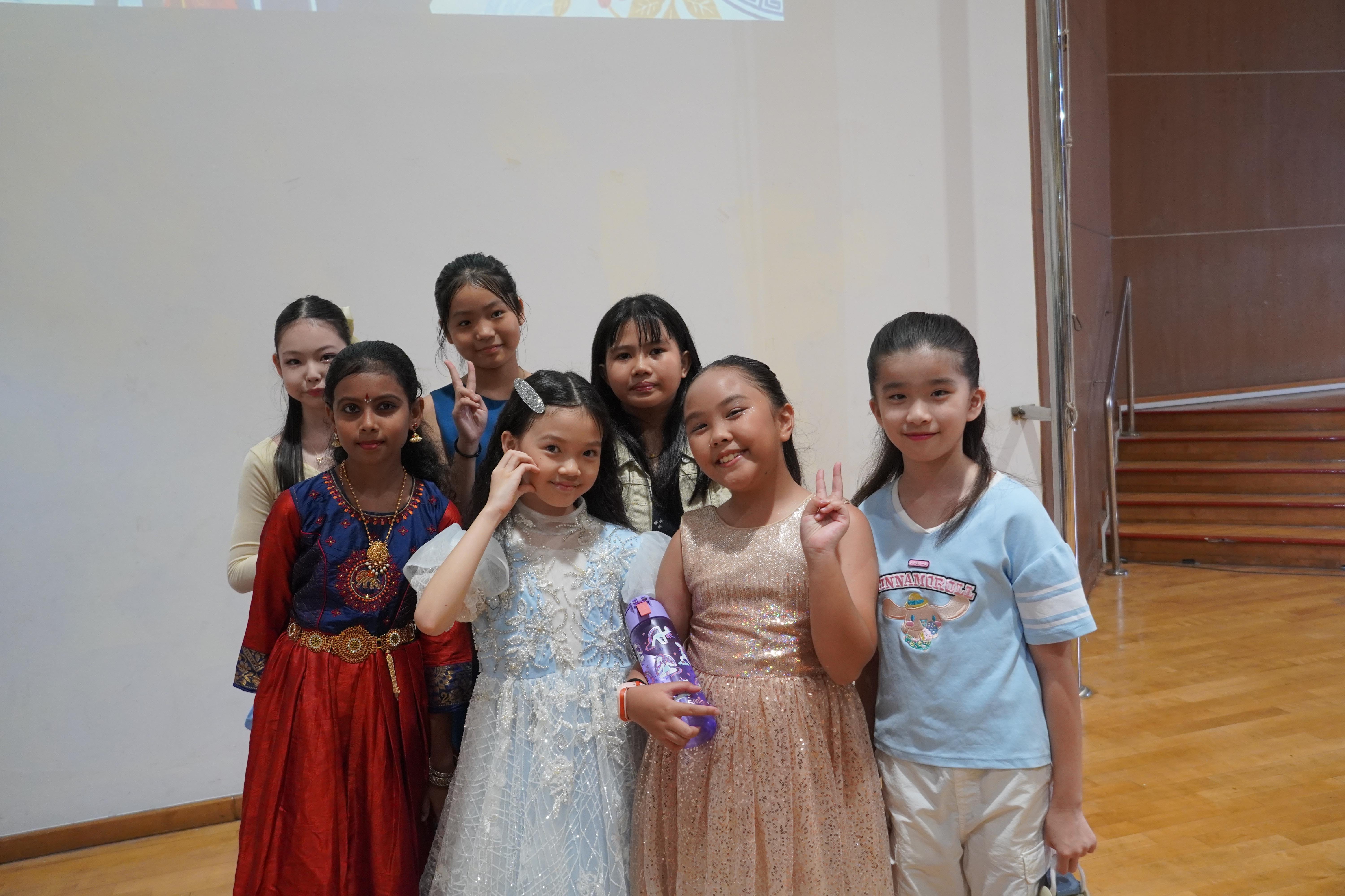 Performance done, memories made! Our young performers gather for a cheerful photo after taking the stage.